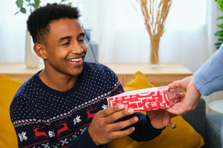 Young African man receiving a Christmas gift.