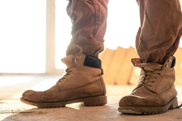 Close-up of work shoes of a builder at a construction site, copy space.