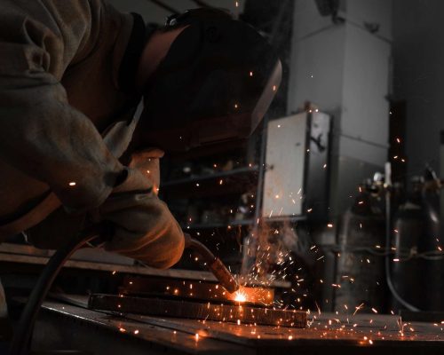 Manufacture Worker Welding Metal With Sparks at Factory